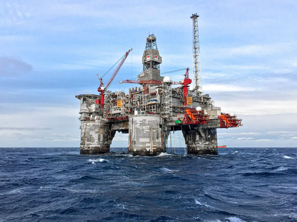 Offshore oil platform in the North Sea under a blue sky